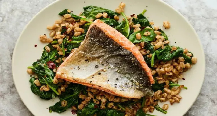 Balanced meal with salmon and greens, featuring natural foods that promote bone health in seniors.