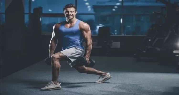 Man performing dumbbell squat as part of natural exercises for male muscle strengthening