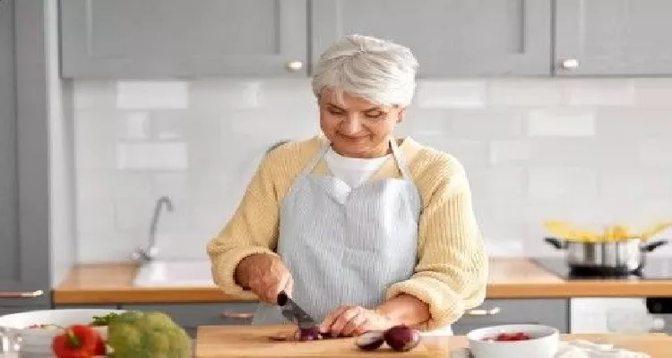 Senior making a low carb diet salad to support diabetes control