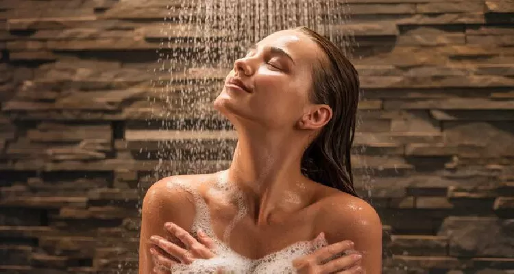 Person meditating in a cold shower for stress relief and your natural health